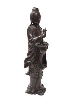 This Kwan Yin carrying basket figure is carved from an oriental Huali