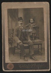 photograph of a man wearing an Ottoman Empire hat and a little girl