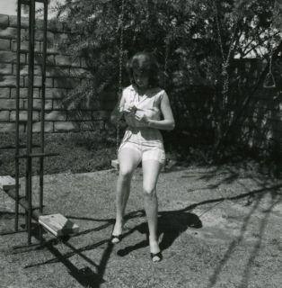 Photo Tempting Pin Up Girl Judy McCutcheon on Swing in Backyard