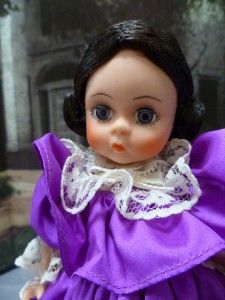 This doll has brown hair and blue eyes.This doll is dressed as Melanie